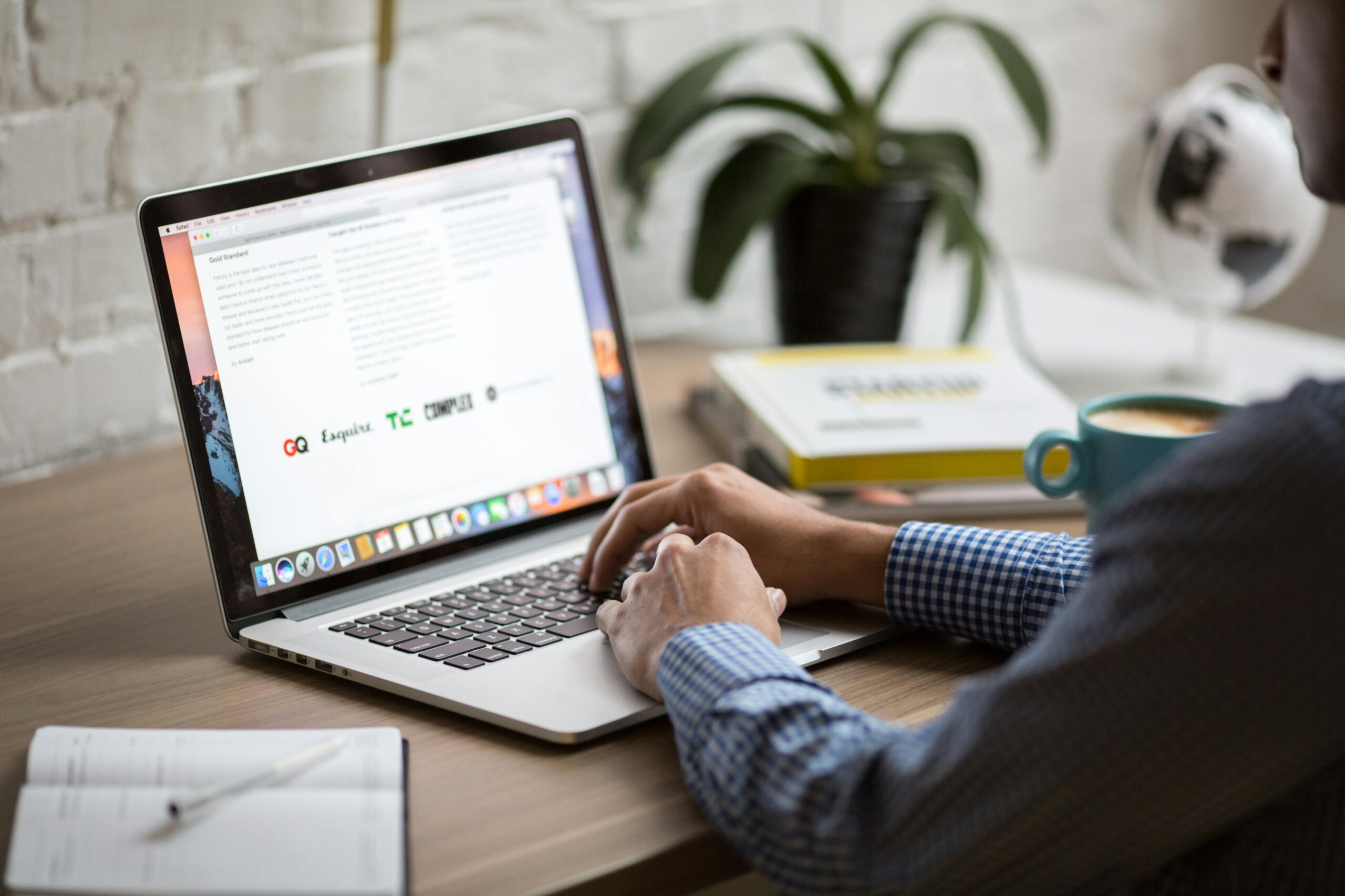 A beautiful, warm, minimalist desk setup featuring a laptop with clean design layouts, a coffee cup, and soft morning sunlight, representing deep focus and an uninterrupted mind in a busy world.