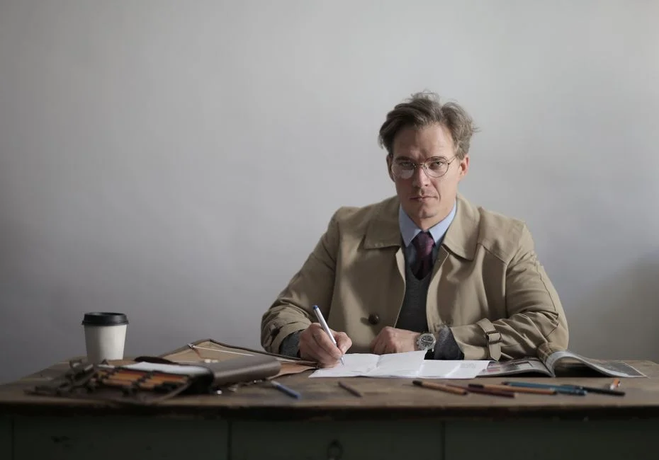A man working at a desk in an office, looking distracted