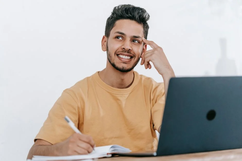 A man in thought, considering a project at his desk