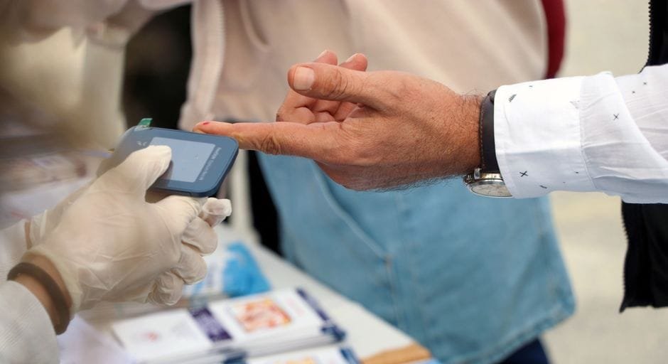 Finger-prick blood glucose test being administered