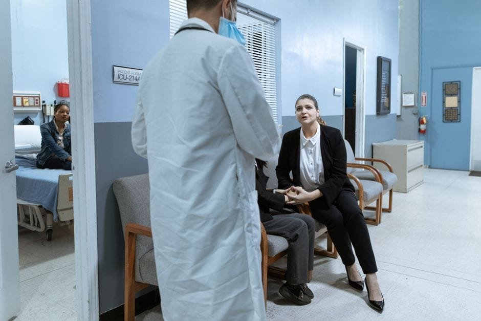 Doctor consulting with a patient in a hospital hallway